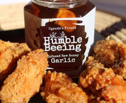 Humble Beeing garlic infused raw honey jar beside crispy fried chicken